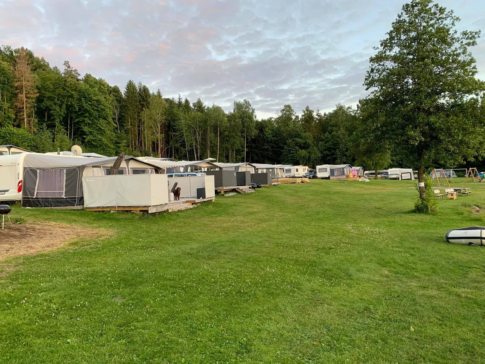Campingplassen på Øra syd med campingvogner, fortelt og stor gressplen